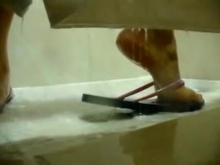 feet in flip flops taking a shower